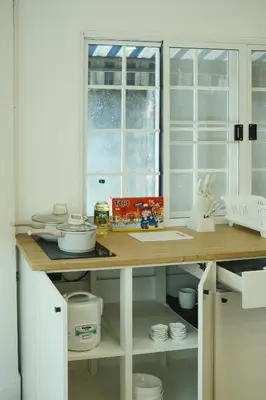 a kitchen with a wooden counter top and a window at Hidden Gems in China town, 2BR in Bangkok