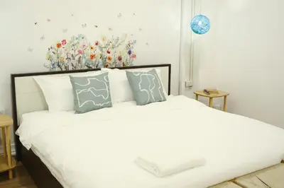 a bedroom with a large white bed with pillows at 3BR in China Town, Rare to find 2 mins from MRT train in Bangkok