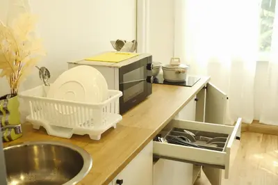 a kitchen counter with a microwave and a sink at 3BR in China Town, Rare to find 2 mins from MRT train in Bangkok