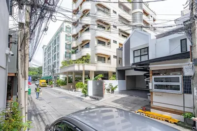 a car parked in front of a tall building at 23 AVA at Saladaeng in Bangkok