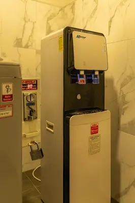 a refrigerator with a computer on top of it at 23 AVA at Saladaeng in Bangkok