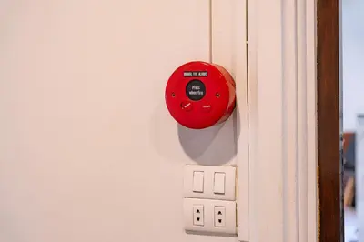 a red button on the side of a lightswitch at 23 AVA at Saladaeng in Bangkok