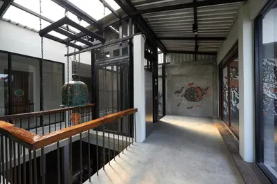 a balcony of a building with a mural on the wall at Cacha Hotel in Bangkok