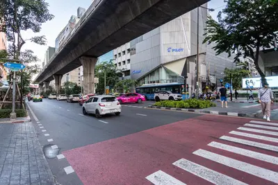 a busy city street with cars parked on the road at A4 Cosy Twin large beds - Silom in Bangkok