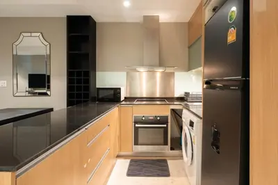 a kitchen with a black refrigerator and a stove at Residence on Sathorn CBD in Bangkok