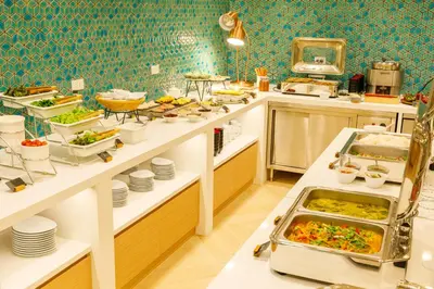 a kitchen with a lot of food on display at Nishitetsu Hotel Croom Bangkok Silom in Bangkok