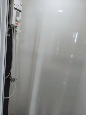 a shower with a glass door in a bathroom at Sukhumvit​ 101 in Phra Khanong