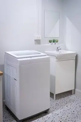 a white bathroom with two sinks and a mirror at A2 Comfortable space wt Kitchen in Bangkok