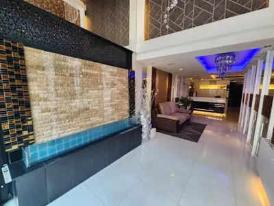 a lobby with a couch and a chair in a building at Masters Suites Hotel in Makkasan