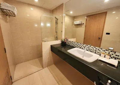 a bathroom with a sink and a shower at Masters Suites Hotel in Makkasan