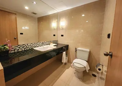 a bathroom with a sink and a toilet at Masters Suites Hotel in Makkasan