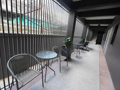 a row of tables and chairs on a balcony at Dancenter Rq Bangkok Huai Khwang in Bangkok