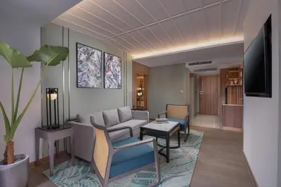 a living room with a couch and a table at Nysa Hotel Bangkok Sukhumvit 11 in Bangkok