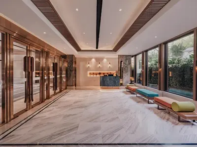 an empty lobby with chairs and a fireplace at Nysa Hotel Bangkok Sukhumvit 11 in Bangkok