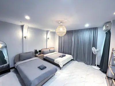 a bedroom with two beds and a television in it at Single house 4BR parking and kitchen in Sukhumvit49-1 in Bangkok