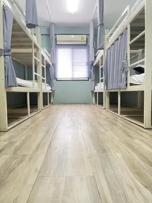 a room with bunk beds and a wooden floor at wonderful hostel khaosan in Bangkok