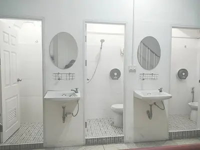 a bathroom with two sinks and a toilet and a mirror at wonderful hostel khaosan in Bangkok