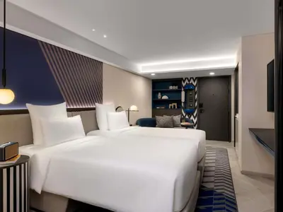 a large white bed in a hotel room at TRIBE Living Bangkok Sukhumvit 39 by AccorHotels in Bangkok
