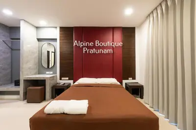 a bedroom with a bed and a sign that reads appliance boutique platinum at Alpine Boutique Pratunam in Bangkok