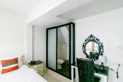 a bedroom with a large mirror and a bed at Narastay @ Phrom Phong in Bangkok