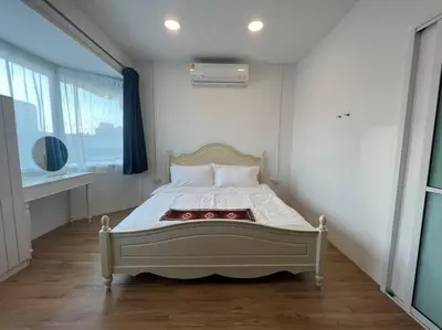 a bedroom with a bed in a room with a window at Roof Top 4BR Top Private Floor, china town, center in Bangkok