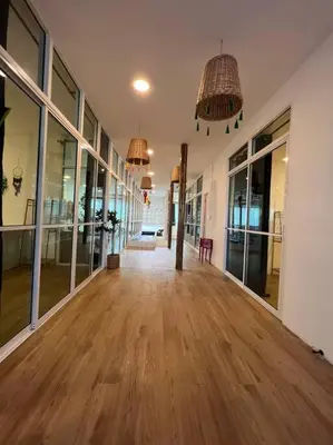 an empty hallway with wooden floors and large windows at Roof Top 4BR Top Private Floor, china town, center in Bangkok