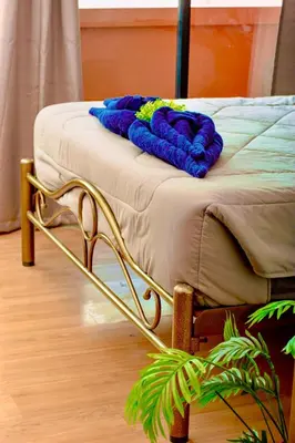 a bed with a blanket on top of it at BM Loft On Nut & Massage in Bangkok