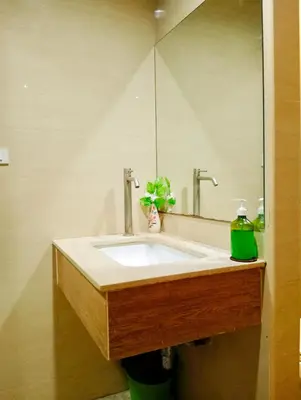 a bathroom with a sink and a mirror at BM Loft On Nut & Massage in Bangkok