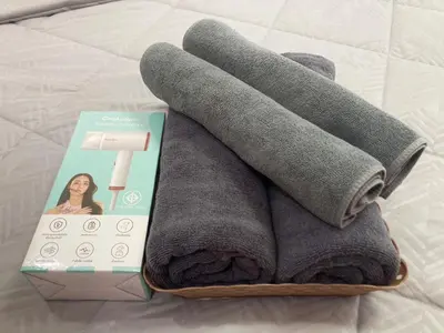 a pile of towels in a box on a bed at Number9 Bangkoknoi BKK Homestay in Bangkok
