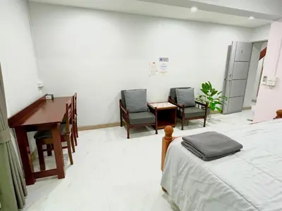 a hospital room with a bed and a desk and chairs at Number9 Bangkoknoi BKK Homestay in Bangkok