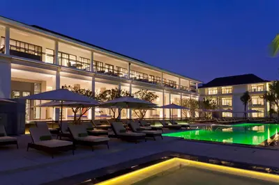 a hotel with a swimming pool in front of a building at U Sathorn Bangkok in Bangkok