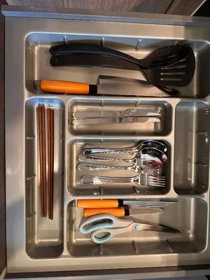 a drawer filled with utensils and other kitchen items at Willow Whisper Nest in Bangkok