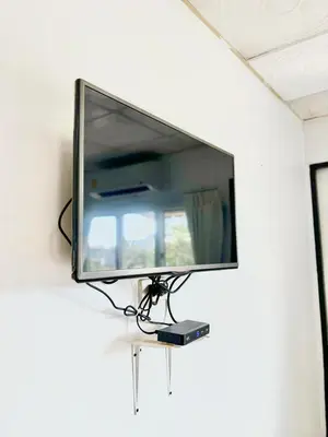 a flat screen tv hanging on a wall at LSN Mansion in Bangkok