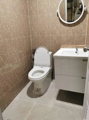 a bathroom with a toilet and a sink and a mirror at NEW! KG home 3 Bedrooms/ Free Wi-Fi in Bangkok