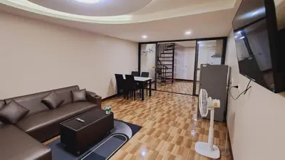 a living room with a couch and a tv and a table at NEW! KG home 3 Bedrooms/ Free Wi-Fi in Bangkok