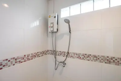 a shower in a bathroom with a shower head at MIQ Ekkamai1 - 5BR house 65 inch TV in Bangkok