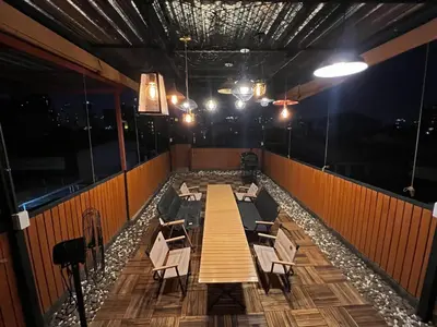 a dining room with a long table and chairs at 4 Bedroom House with Beautiful Rooftop near BTS Ekkamai in Bangkok