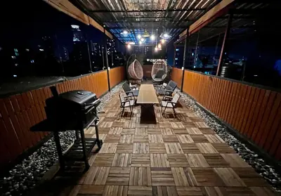 a room with a table and chairs in a building at 4 Bedroom House with Beautiful Rooftop near BTS Ekkamai in Bangkok