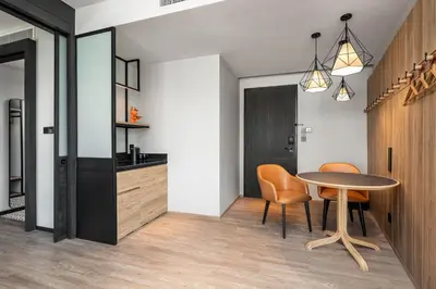 a kitchen and dining room with a table and chairs at Moxy Bangkok Ratchaprasong by Marriott in Bangkok
