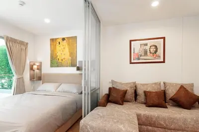 a bedroom with a bed and a couch at Fully Furnished Studio Apt. 110 in Bangkok