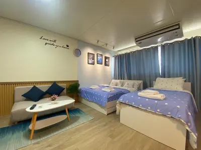 a small room with two beds and a table at PTJ Style Condotel คอนโดเมืองทอง P1 in Ban Song Hong