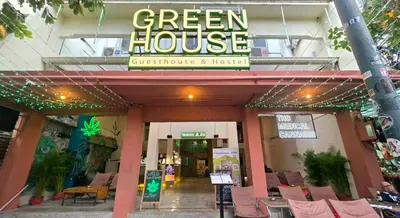 a green house restaurant with chairs in front of it at Greenhouse Bangkok Khaosan in Bangkok