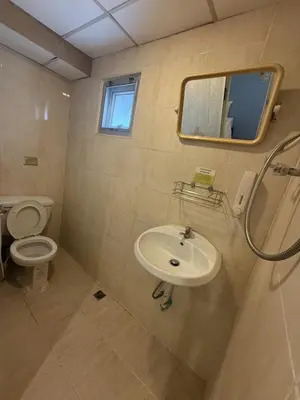 a bathroom with a sink and a toilet and a mirror at Greenhouse Bangkok Khaosan in Bangkok