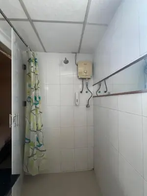 a bathroom with a shower with a shower curtain at Greenhouse Bangkok Khaosan in Bangkok