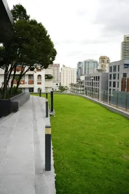 a park with a green field in the middle of a city at Circle Rein Sukhumvit 12 two bedrooms apartment in Khlong Toei