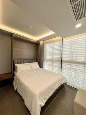 a bedroom with a large bed and two windows at Circle Rein Sukhumvit 12 two bedrooms apartment in Khlong Toei