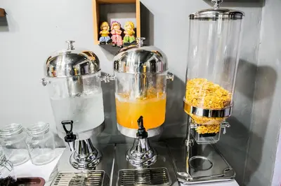 a kitchen counter with a blender and an orange drink at Bangkok Cozy Home @Khaosan Road in Bangkok
