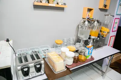 a counter with a table with food and a blender at Bangkok Cozy Home @Khaosan Road in Bangkok