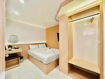 a small bedroom with a bed in a room at Thrive Hotel in Bangkok