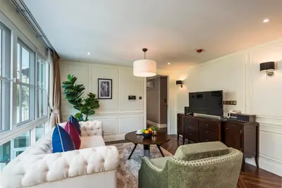 a living room with a white couch and a table at The Elite @ Thong Lor 25 in Bangkok